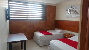 Voodi või voodid majutusasutuse Hotel Murali - Cerca del Aeropuerto de Guayaquil toas
