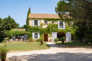 a large stone house with a large yard at Mas des Prevots B&B in Noves