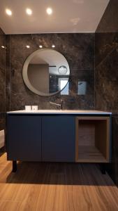 a bathroom with a large mirror on the wall at Casa Del Sol - Luxury Villas in Himare