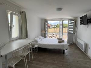 a bedroom with a bed and a table and chairs at Tours, Touraine et Chateaux de la Loire in Fondettes