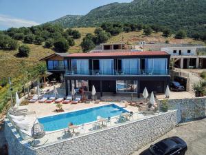 a house with a swimming pool on a hill at Casa Del Sol - Luxury Villas in Himare