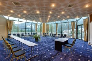 a conference room with tables and chairs and windows at Hotel Mara in Sinaia +61 photos
