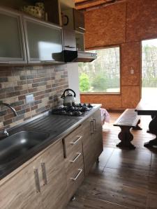 a kitchen with a sink and a stove at La Casa de las Estrellas in Suesca