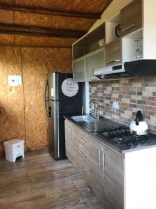 a kitchen with a stove and a refrigerator at La Casa de las Estrellas in Suesca +25 photos