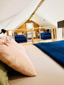 a bedroom with a bed in a tent at Domek TRZY BABY in Dołgie