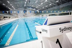 a large swimming pool in a large building at Parkside & City view in Sydney Olympic Park in Sydney