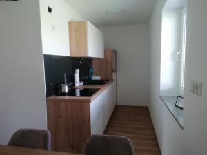 a kitchen with a sink and a counter at Apartment Sunset in Maribor
