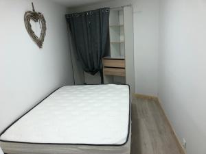 a bed sitting in a room with a mattress at appartement 12 couchages proche piste ski et de randonnées du lioran in Le Lioran