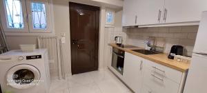 a kitchen with a washing machine and a washer at Elise Corfu City Apartment in Ágios Rókkos +6 photos