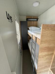 a small room with two bunk beds in it at H&S Mobile Home in Privlaka