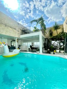 a swimming pool with a pool noodle in a house at White Penthouse-Rooftop Pool Private -Central City in Ho Chi Minh City