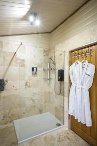 a bathroom with a shower with a glass door at Muir-lan cabin in Lochinver +38 photos