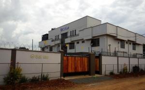 a white building with a fence in front of it at Sai Inn Eldoret in Eldoret