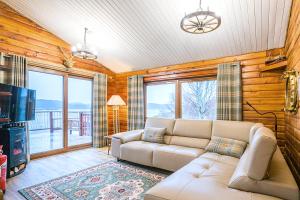 a living room with a couch and a tv at Muir-lan cabin in Lochinver