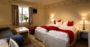 Ένα ή περισσότερα κρεβάτια σε δωμάτιο στο Gammelgården