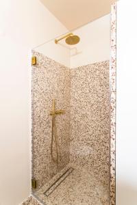 a shower with a cross on the wall at Enjoy Lisbon Tróia in Troia