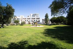 a park with a playground in front of a building at Enjoy Lisbon Tróia in Troia