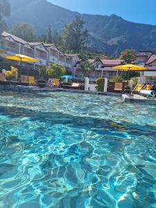 a swimming pool with blue water in a resort at Hotel Des Neiges in Cilaos