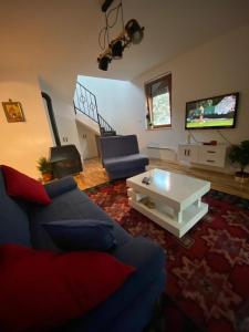 a living room with a blue couch and a white coffee table at House Reko in Novi Grad