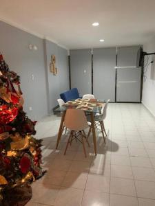 a dining room with a table and a christmas tree at Apartamento en el Laguito - Cartagena cerca al mar in Cartagena de Indias