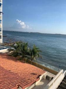 a view of a beach with palm trees and the ocean at Apartamento en el Laguito - Cartagena cerca al mar in Cartagena de Indias