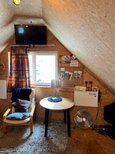 a room with a table and a chair and a window at Gemütliches Gästehaus mit kleiner Terasse in Schloß Holte-Stukenbrock