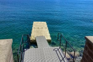 a stairway leading into the water near the ocean at The Treehouse in Joseph