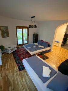 a living room with two beds and a wooden floor at House Reko in Novi Grad
