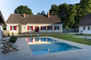 a house with a swimming pool in front of a house at Haselmühle in Sichauf