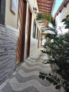 a hallway of a building with a plant on the side at Pousada da Onça in Baía Formosa