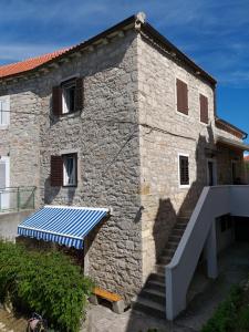 a stone building with a solar panel on the side of it at Diana in Zlarin