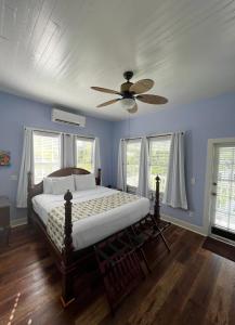 a bedroom with a bed and a ceiling fan at The Porch on Frances Inn - Adults Exclusive in Key West