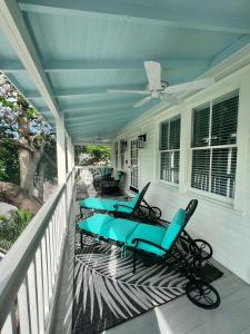 two blue lounge chairs on a porch at The Porch on Frances Inn - Adults Exclusive in Key West