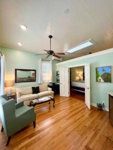 a living room with a couch and a ceiling fan at The Porch on Frances Inn - Adults Exclusive in Key West