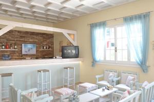 A television and/or entertainment centre at Iliada Beach Hotel