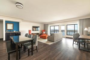 a living room with a table and chairs and a couch at Galt House Hotel, A Trademark Collection Hotel in Louisville