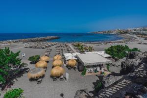 an aerial view of a beach with umbrellas and chairs at Bleu Torviscas in Adeje