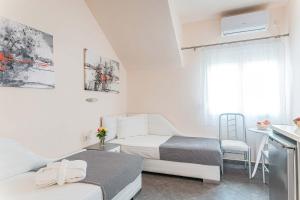 Postel nebo postele na pokoji v ubytování Marinis Boutique Rooms