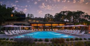 a swimming pool with white chairs and a building at Montage Healdsburg in Healdsburg