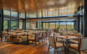 a restaurant with tables and chairs and windows at Montage Healdsburg in Healdsburg
