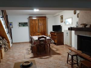 a living room with a table and a television at La casa di Walter e Rosa in Castel di Sangro +10 photos