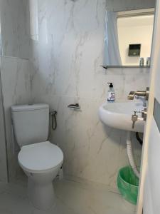 a bathroom with a toilet and a sink at Neo Saturn Residence in Saturn +66 photos