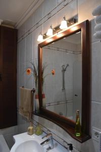 a bathroom with a sink and a large mirror at El Aroma del Dulce in Setenil +42 photos
