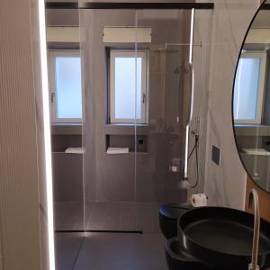 a bathroom with a black sink and a mirror at Apartments for you 2 in Matera +14 photos