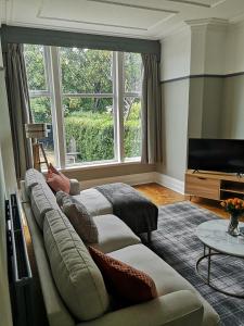 a living room with a couch and a flat screen tv at 34 One in Lytham St Annes