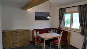 a living room with a table and a couch at Rief Ingrid und Hubert in Tannheim
