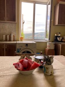 a kitchen with a bowl of fruit on a table at NAREK B&B in Goris