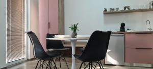 a kitchen with a table with four black chairs at G&G Suites in Ohrid