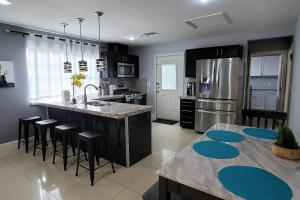 a kitchen with a large island with a counter top at K - Fully remodeled and professionally decorated in Las Vegas