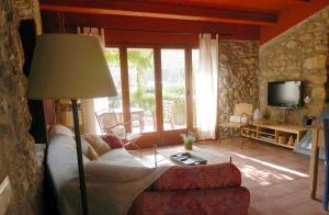 a living room with a couch and a television at Can Pol in Llança